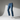 Generate a high-quality image (800x800px) of a floating pair of jeans on a 3D mannequin.

Style and details:
- The jeans should have a straight-leg fit
- Denim color: Medium-tone washed blue (azul deslavado medio)
- The jeans must appear to be floating in the air on a 3D invisible mannequin
- Background: Professional studio setup, minimal, with dramatic directional lighting and soft shadows to highlight texture and silhouette
- The image should be crisp, modern, and fashion editorial style
- No logos, no te